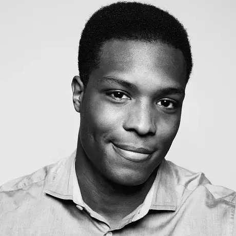 Headshot of Josiah Bates wearing a light button down shirt