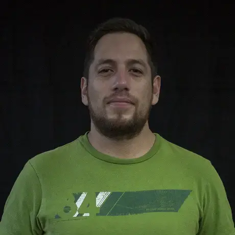 Headshot of a man wearing a green shirt
