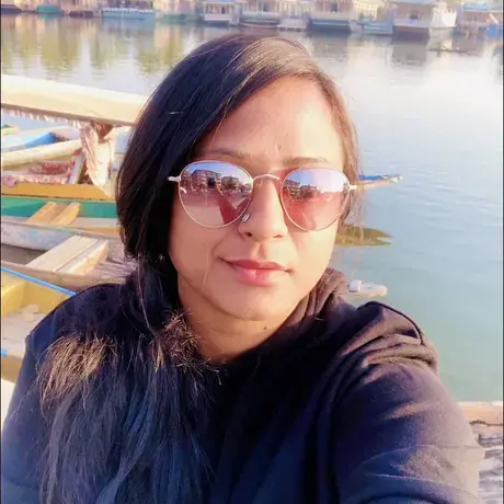 A woman with long hair wearing sunglasses and a dark sweatshirt