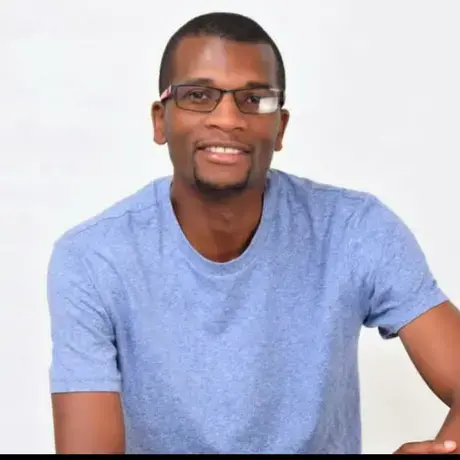 A man with glasses wearing a blue t-shirt