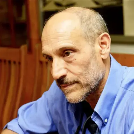 A man wearing a blue button down