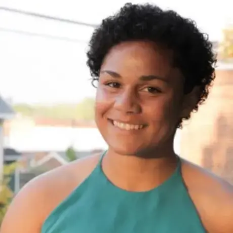 Headshot of Halle wearing a green shirt outside