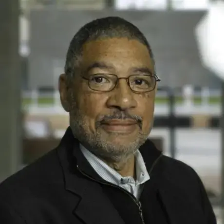 Headshot of Linn Washington wearing glasses and a collared shirt