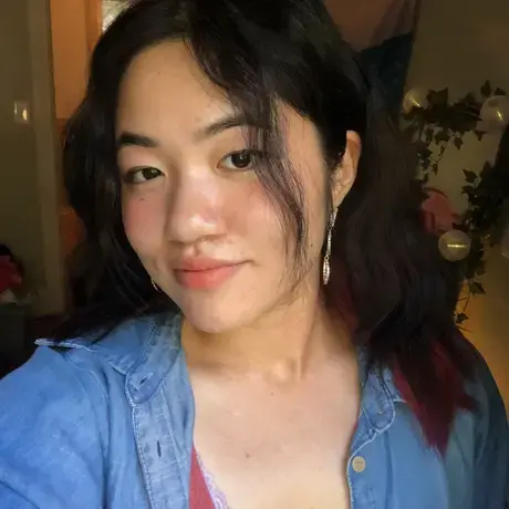 Headshot of Ashley wearing a blue button-down