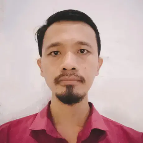 Headshot of Aditya wearing a red collared shirt