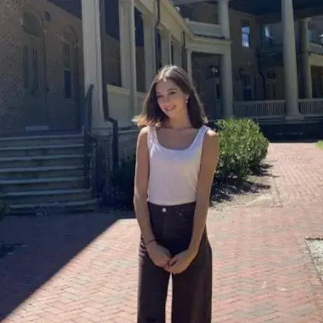 Image of Hannah standing outside a campus building