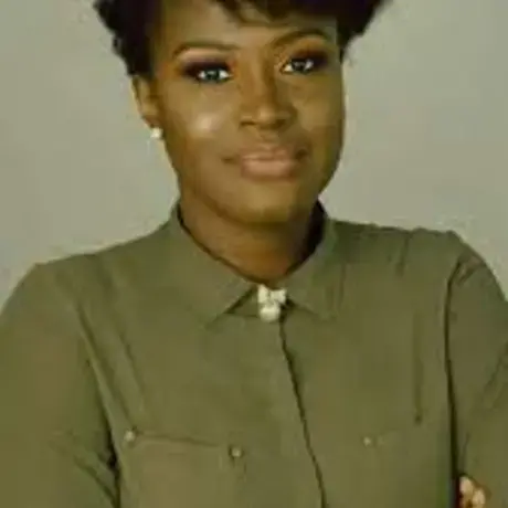 Headshot of Ugochi wearing green