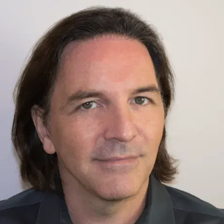 Headshot of man with long brown hair