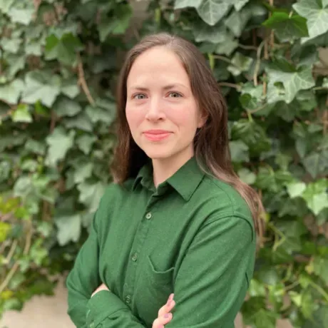 Woman in green shirt with long brown hair
