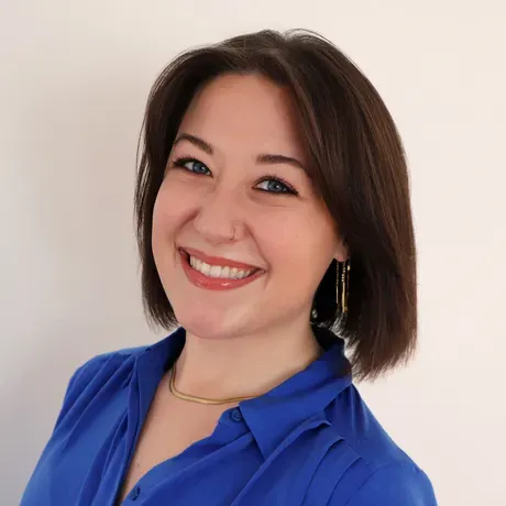 Headshot of brunette woman in blue button down