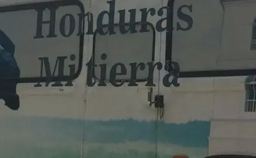 A bus in San Pedro Sula awaits deportees from detention centers in the US. Image by Emily Gogolak.