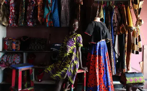 South Sudanese designer Winnie Godi is posing for a photo in her shop in Juba. Image by Andreea Campeanu.&nbsp;South Sudan, 2018.