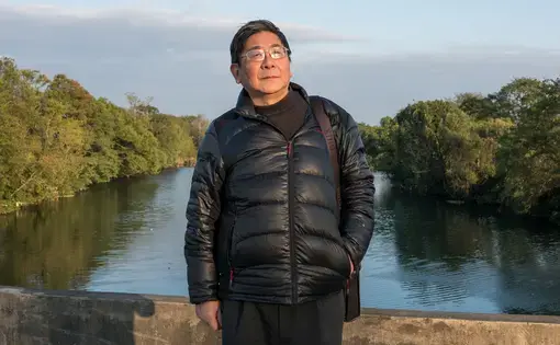 The author Tan Hecheng stands on "Widow's Bridge," where dozens of people were clubbed to death and thrown into the river in a wave of genocide that took place in 1967. These sorts of hidden histories still haunt the new superpower. Image by Sim Chi Yin/ VII Photo Agency. China, 2016.