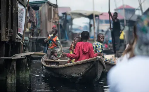 Child rowing a canoe in Makoko. Image by Alucardion / Shutterstock.com. Nigeria, 2019.
