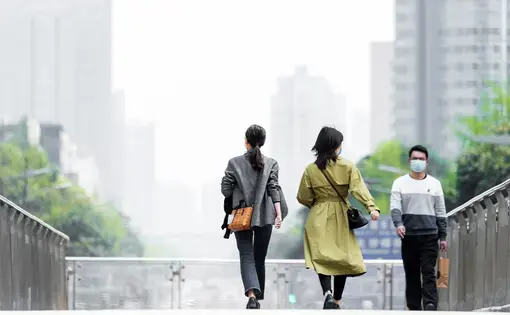 Shopping citizens in China's downtown center wear masks as the city recovers from the COVID-19 epidemic. Image by B.Zhou/Shutterstock. China, 2020