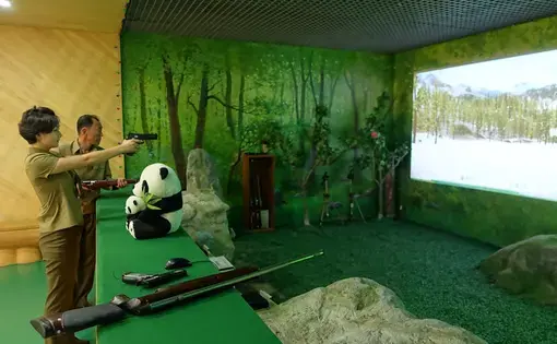 A North Korean citizen enjoying herself at a shooting range in Pyongyang. Image by Laya Maheshwari. North Korea, 2016.