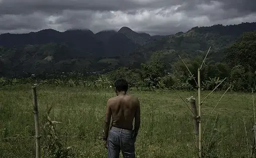 Sanga-Minson, 64, surveys his recently reclaimed land in the Barangay T'konel region. Image by Chien-Chi Chang. Philippines, 2018.