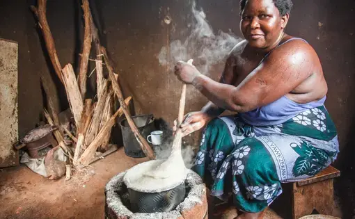 Rose Kandodo is cooking nsima, a maize porridge, on an improved cook stove in Nessa village. Image by Nathalie Bertrams. Malawi, 2016.