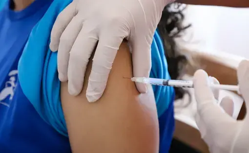 A medical worker administers a vaccine in Rio de Janeiro. Image by&nbsp;Andre_MA / Shutterstock.&nbsp;Brazil, 2020.