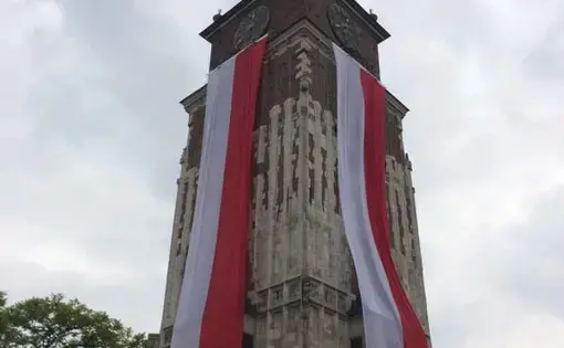 Kraków’s town hall decorated for Flag Day. Image by Ben Mauk. Poland, 2017.