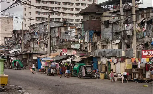 A Manila street scene showing informal housing and shops.
