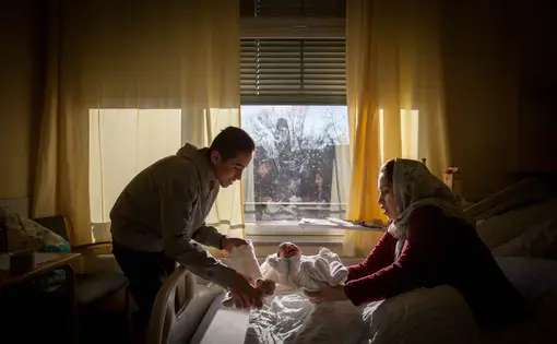 Milad's family of five, refugees from Afghanistan, live in a small room in a refugee center close to the airport in Dusseldorf. Image by Diana Markosian. Germany, 2016.