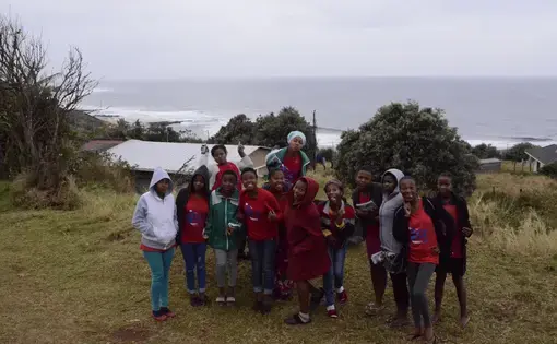 A group of young women activists stand together by the seaside. Image by Amy Maxmen, South Africa, 2016.