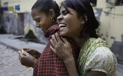 Two friends laugh together