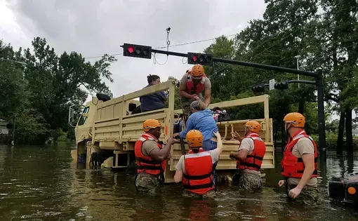 Texas National Guard soldiers rescue a civilian in flooded areas around Houston, Texas, on 27 August, 2017. Image by 1Lt. Zachary West, 100th MPAD. United States, 2017.