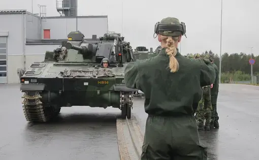 A female mechanized infantry recruit guides her crew as they learn how to repair broken vehicle tracks in Boden on September 12. Image by Teresa Fazio/Foreign Policy. Sweden, 2018.