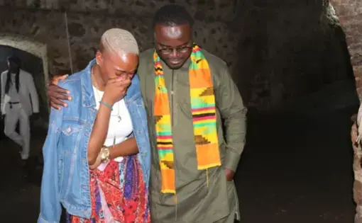 A tour guide comforts NAACP Youth and College Director Dena Loftin inside the Cape Coast Slave Castle on Ghana's coast. Africans captured by slave traders were herded inside small dungeons and endured horrendous conditions before being put on a ship to lands unknown. Those who died were thrown to the sharks; those who survived were sent across the sea in chains. Image by NAACP. Ghana, 2020.