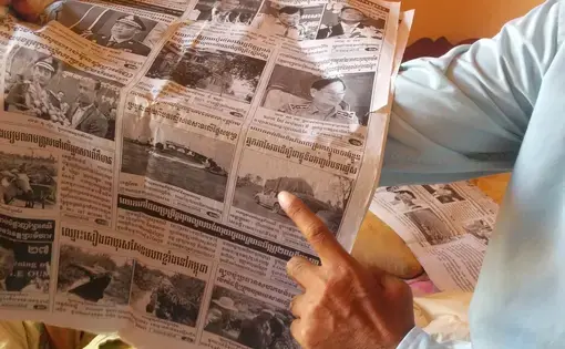 Journalist Sa Piseth shows one of his articles on illegal logging in the Reaksmey Kom Khmer newspaper. Image by Saul Elbein. Cambodia, 2014. Journalist Sa Piseth shows one of his articles on illegal logging in the Reaksmey Kom Khmer newspaper
