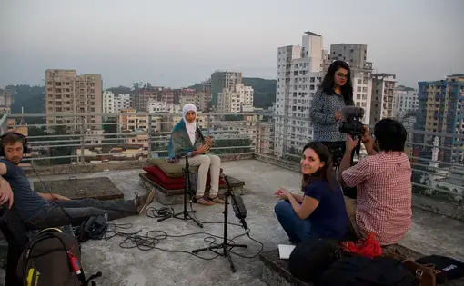 Rohingya musician on a rooftop in Bangladesh.