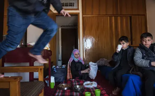 A Syrian refugee in Greece, Ilham Alarabi thought moving from a tent to a hotel would help her family. But with five sons all under the age of seven, it has proved to be chaotic. Image by Lynsey Addario. Greece, 2016.