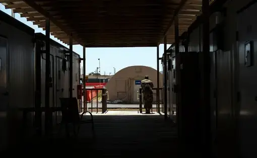 An obsolete airstrip with tents and containerized housing at Guantánamo Bay is the site of the death-penalty trial of the men accused of plotting the Sept. 11, 2001, attacks. Image by Doug Mills / The New York Times. United States, 2019.