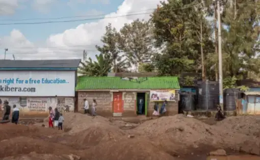 Christ Miracle Church, center, originally built as a public toilet, in Kibera, Nairobi. Image by Peter DiCampo. Kenya, 2018.