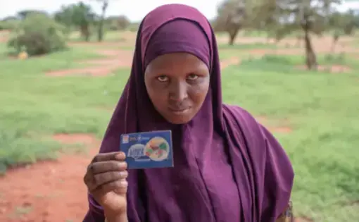 Farhiya Shimay Garore, 24, in Boji-Yeri, Wajir County. A resident of Boji-Yeri, she was registered into the World Food Programme project that targeted malnourished mothers and children under five. She was to receive cash transfers amounting to $120 over a period of three months. By the time the period ended she had only received $40. Image by Peter DiCampo. Kenya, 2019.