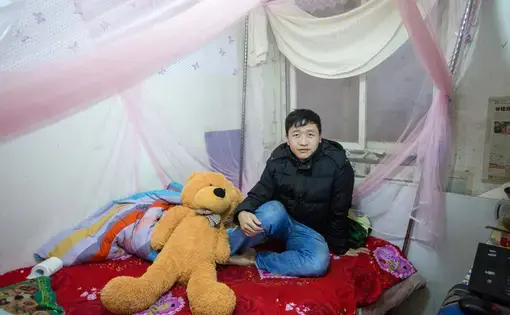 Zhang Haihai is a 26-year-old chef in a Cantonese restaurant. He shares his 10-square meter room with his girlfriend, a waitress at a restaurant. Image by Sim Chi Yin. Beijing, 2014. Media file: 03-zhanghaihai-01.jpg