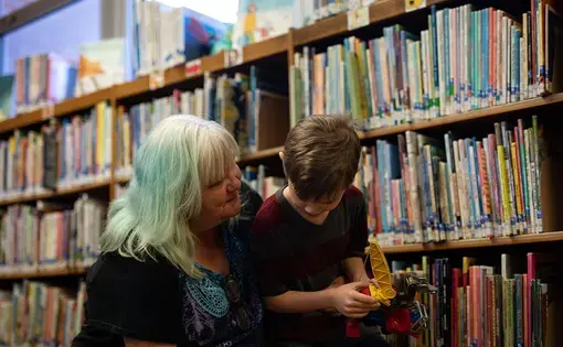 Anna Koski spends time with her grandson Aiden at the Miami Public Library. Aiden is the son of Koski’s younger daughter Jennifer. She hasn’t seen Elizabeth’s kids for several years. Image by Destiny Green / KOSU &amp; The Frontier. United States, 2020.
