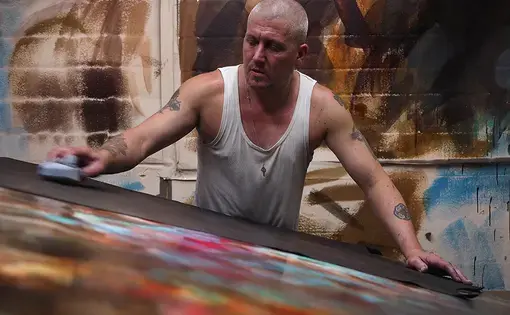Dean Morrison, an employee at Brooklynn Custom Leather Works, is “tipping” or spreading dye on finished leather. The company works with furniture makers and interior designers. Image by Larry C. Price. United States, 2016.