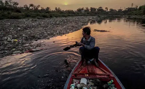 Dedi Rahman, 65, remembers swimming in the Citarum River when he was a boy. Today, the river is considered one of the world’s most polluted waterways, contaminated by factory effluent, sewage and trash. Rahman gathers cans and bottles to recycle for cash. Image by Larry C. Price. Indonesia, 2016.