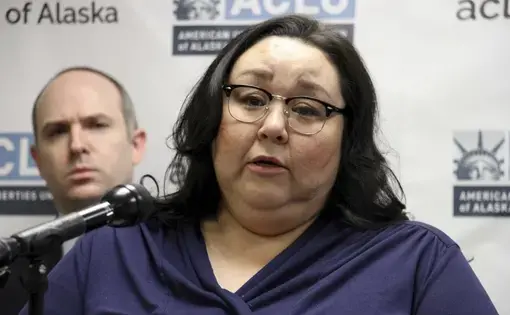 Clarice Hardy speaks at a news conference Thursday, Feb. 20, 2020, in Anchorage, Alaska. The American Civil Liberties Union of Alaska filed a lawsuit Thursday on Hardy's behalf against the city of Nome, Alaska, and two former officers for failing to investigate the sexual assault report filed by Hardy, a former police dispatcher. On the left is Joshua Decker, executive director of the ACLU of Alaska. Image by AP Photo/Mark Thiessen. United States, 2020.