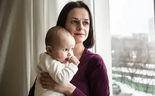 Nika Ivanova, a young mother with HIV, spends time in her apartment in Moscow with her 6-month-old daughter, Yeva. Image by&nbsp;Olga Ingurazova. Russia, 2017.