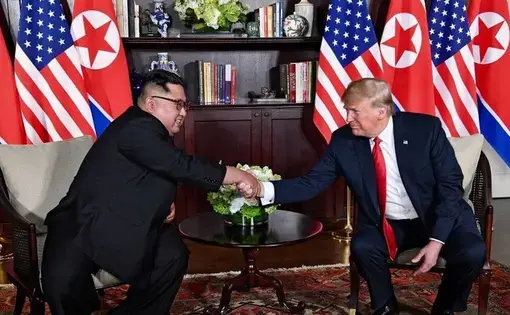 Trump and Kim shaking hands in the summit room during the DPRK-USA Singapore Summit. Image by Shealah Craighead/Wikimedia Commons. Singapore, 2018.