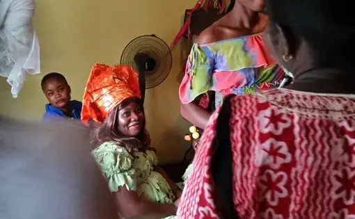 Salome Karwah, Ebola survivor and Ebola nurse, waits in her sister's bedroom on her wedding day as her aunts ask the groom's family for money, in a Liberian tradition known as Bride Price. In February 2017 she died from complications during childbirth. Image by Seema Yasmin. Liberia, 2015.