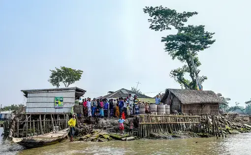 Villagers cluster on Polder 32, an artificial island in southwest Bangladesh with an uncertain future. Image by Tanmoy Bhaduri. Bangladesh, 2017.