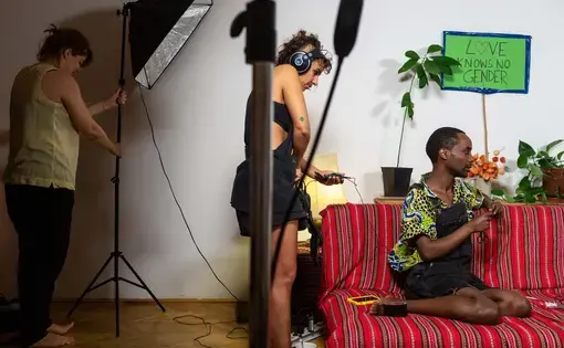Faris (right), 35, from Addis Ababa, Ethiopia identifies as non-binary, and now lives in Vienna, Aurstia, where he was granted political asylum in July 2017. As part of a series of online videos about LGBTI+ rights in Amharic, Faris chats with his co-host Noël during a break in filming in his living room. Image by Bradley Secker. Austria, 2020.points, and was arrested and tortured by both. Image by Bradley Secker. Germany, 2020.
