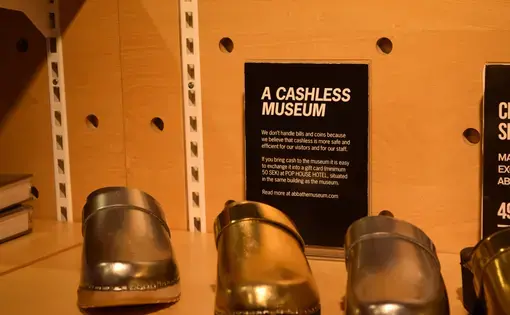 At the ABBA Museum in Stockholm, visitors can purchase gold clogs — but not with bills or coins. Image by Amelia Lucas. Sweden, 2017.