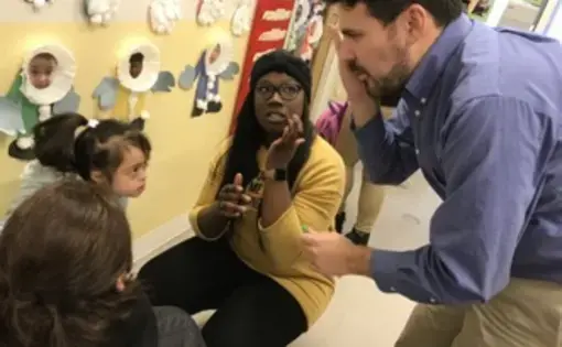 Egan was negotiating between a parent and a teacher. The girl accidently scratched herself during the day, and Egan was asking the girl questions in Spanish. Image by Thea Gu. United States, 2017.