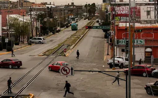 Juárez — the largest city in Chihuahua, Mexico — is home to around 1.3 million residents, according to 2010 data from Mexico’s National Institute of Statistics and Geography. Pedestrians cross the street in downtown Juárez. Image by Erika Schultz. Mexico, 2020.